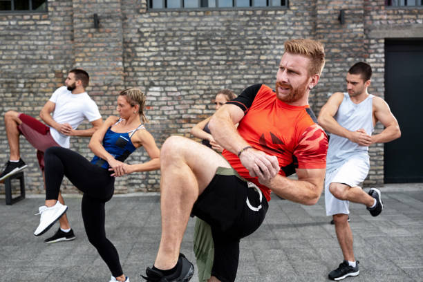 istock Athletes performing a knee kick 1182618841