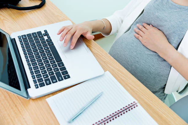 istock Pregnant woman working on laptop 1182620317