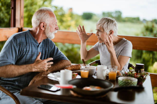 istock Angry mature couple arguing during breakfast on a terrace. 1182620395