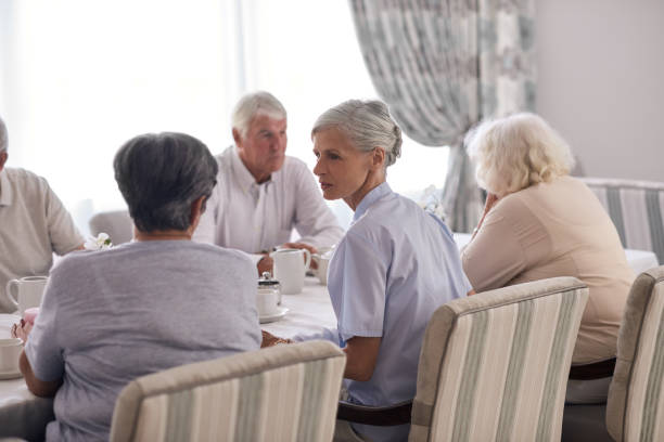 istock Seniors talking over tea in a retirement home dining room 1182620526