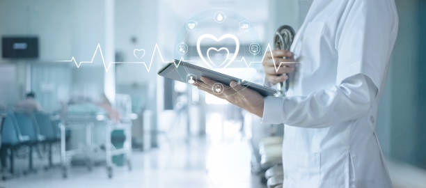 istock Cardiologist doctor with stethoscope analyzing patient data on tablet with icon network connection on modern virtual screen networking interface, healthcare, medical technology and patient concept. 1182622521