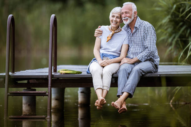 Happy senior couple enjoying on a pier.