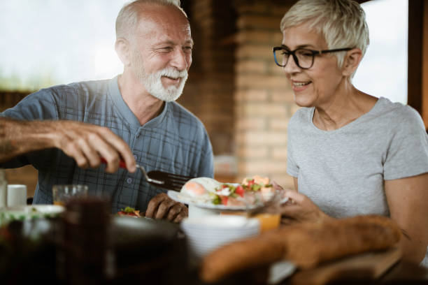 istock Happy mature couple talking while having breakfast on a balcony. 1182622773