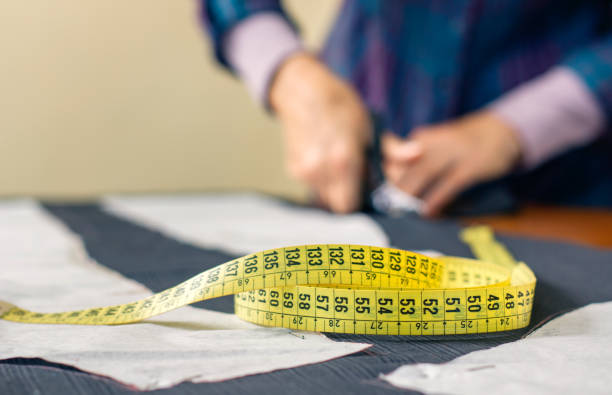istock Measuring tape with dressmaker cutting in background 1182623152