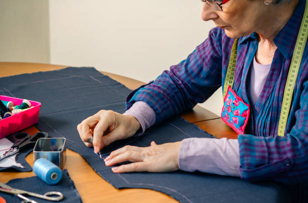 istock Senior female seamstress sewing cloth 1182623167