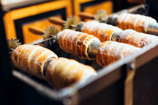 Traditional Czech Christmas culture pastry trdelnik. Traditional Czech Christmas culture pastry trdelnik. This bread prepared on the street from yeast dough, baked on metal skewers trdelník stock pictures, royalty-free photos & images