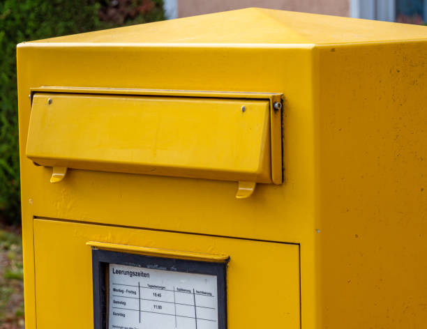 istock yellow Mailbox in Germany on the street 1182625489