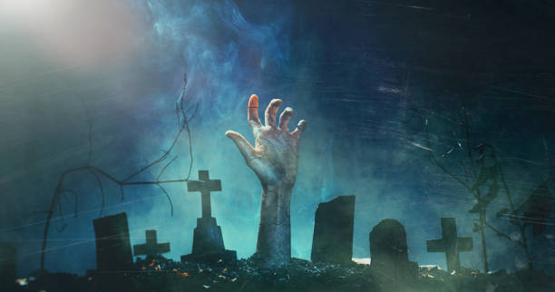 Zombie Hand Rising Out Of A Graveyard In Spooky Night. Horror Halloween Holiday event banner background concept stock photo