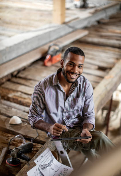 istock Young Man Renovating the Attic 1182625639