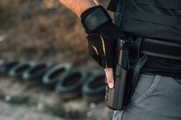 istock Pulling out a gun from the holster on belt, close-up. 1182627382