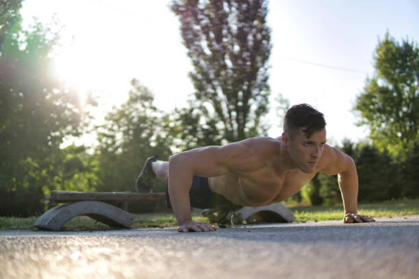 istock Muscular man doing push-ups. Concept of strong guy exercising. 1182627653