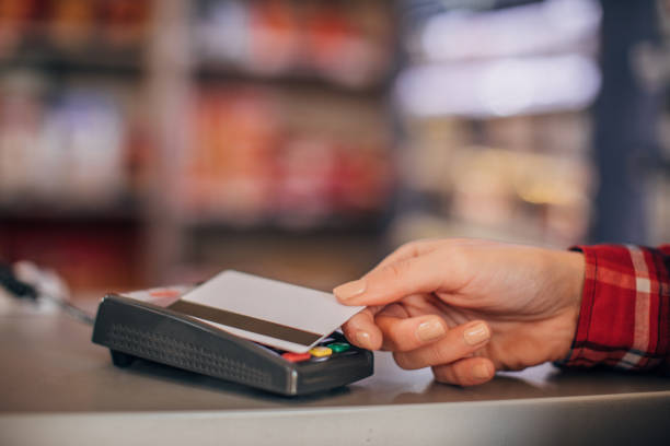 istock Woman paying with credit card 1182628415