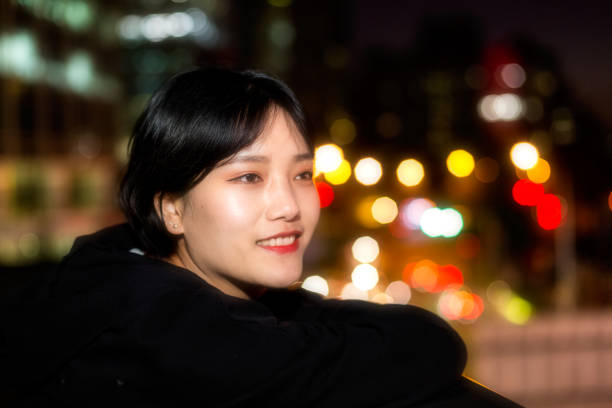 istock Girl on city lights background 1182629186