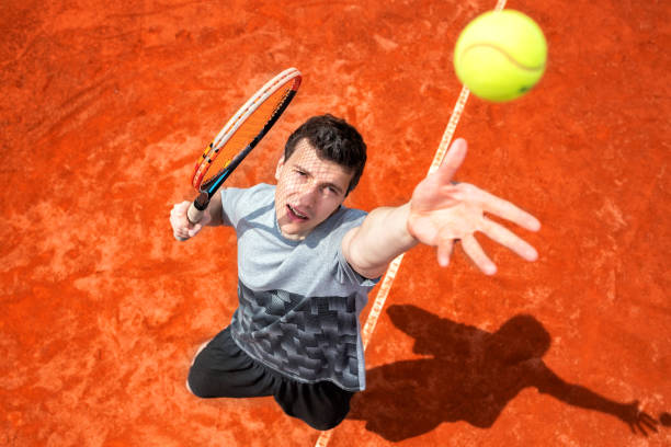 istock Tennis serve technique being practiced on the court 1182629865