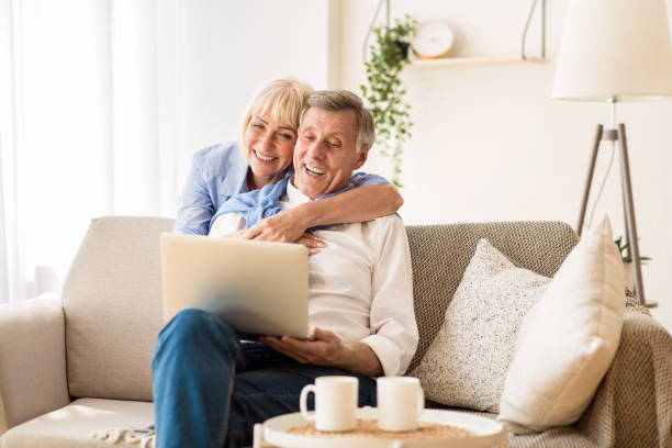 istock Happy senior couple having video call on laptop 1182629885