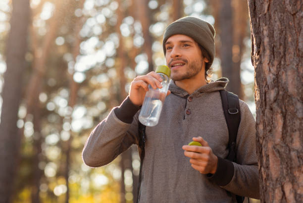 istock Young tourist with backpack drinking water, having break 1182629898