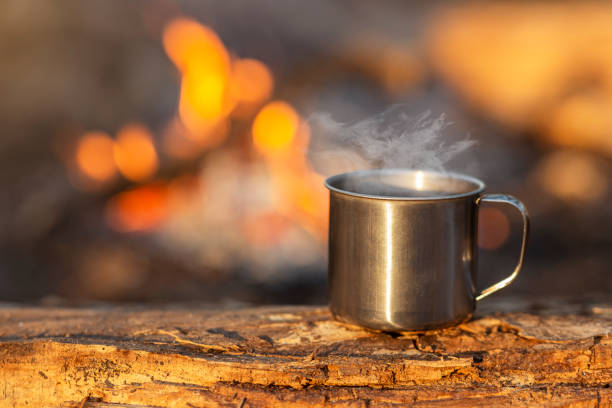 istock Travel cup on wood on fire background 1182630006