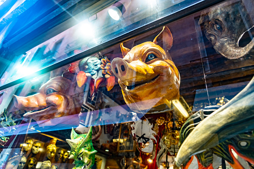 Candid image of colorful masks in a gift shop window in Venice .