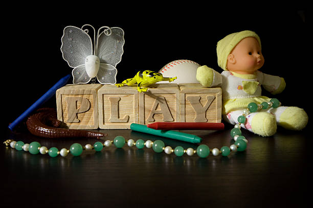 Wooden blocks spell the word PLAY.  There are also childrens toys.
