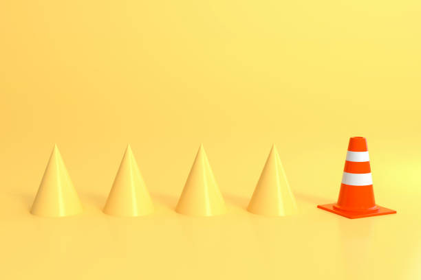 istock Traffic cone and yellow cones in yellow room 1182632301