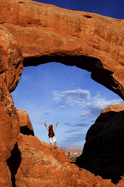 istock Hiker Under Arch Celebrating His Hike To The Top 118263454