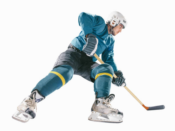 Caucasian ice hockey Players in dynamic action in a professional sport game play in hockey under stadium lights.