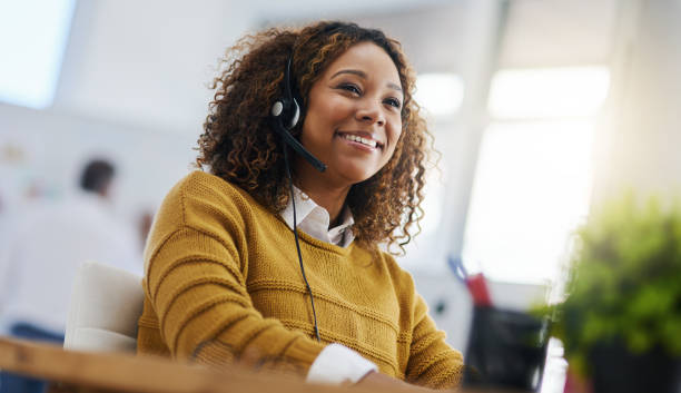 Our friendly agents are always ready to help Shot of a female agent working in a call centre headset stock pictures, royalty-free photos & images