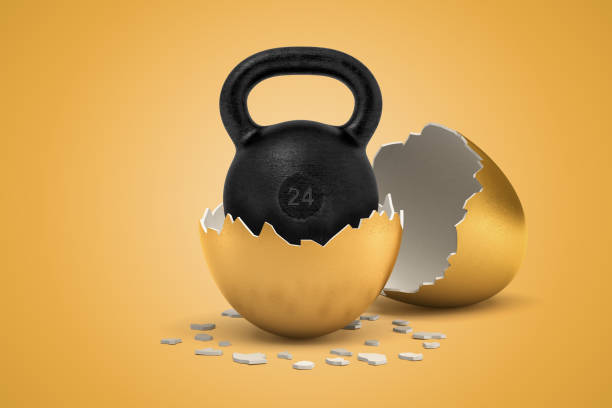 istock 3d rendering of black 24 kg kettlebell that just hatched out from golden egg. 1182637308