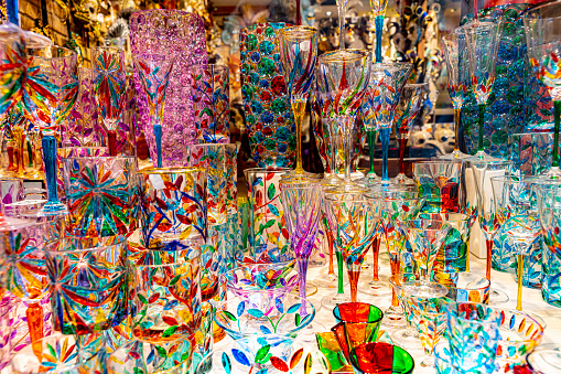 Close-up window display of coloured Venetian glass gifts in a shop window in Venice .