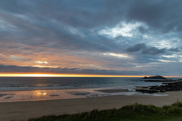 istock Sunlight reflected on the beach as the tide recedes 1182641882