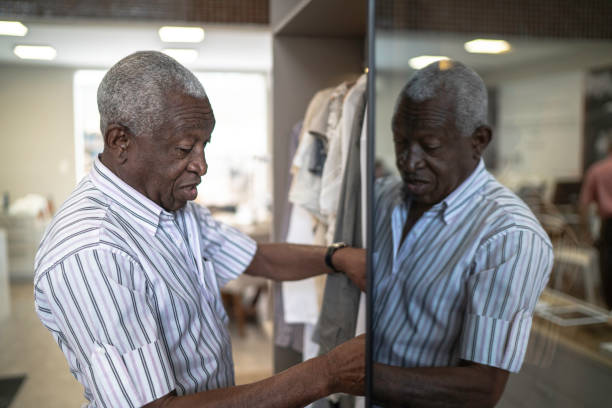 istock Senior man selecting clothes at home 1182642452