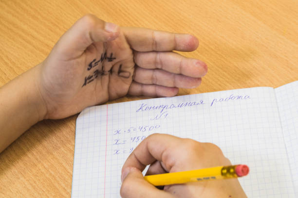 A plus (A+) grade with 100 percent written in red pen on notebook paper.