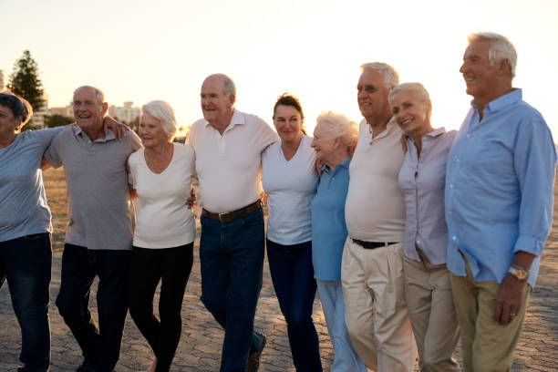 istock Smiling seniors walking along a seaside boardwalk together at sunset 1182643051