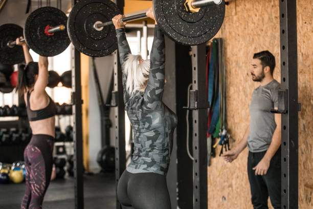 istock Women weightlifting and personal trainer is with them 1182644953