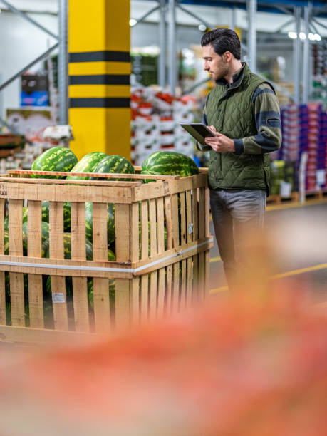 istock Male worker checking watermelon shipment in warehouse 1182645051