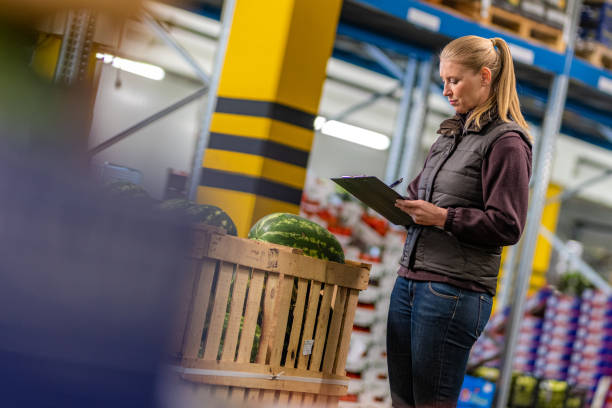 istock Female worker checking watermelon shipment in warehouse 1182645075