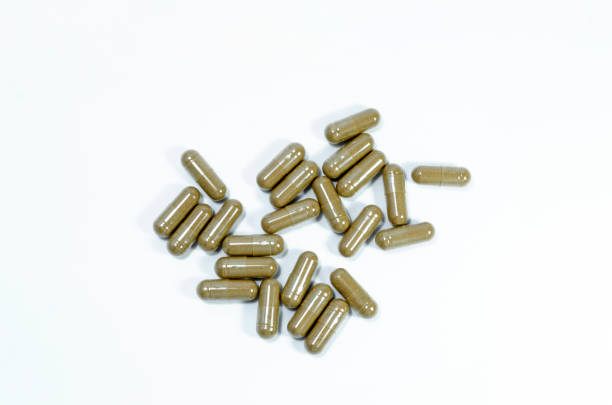 istock Herbal drugs capsules on top view isolated on white background 1182646148