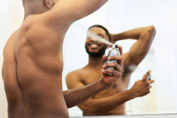 istock Handsome shirtless african man putting deodorant in bathroom 1182646197