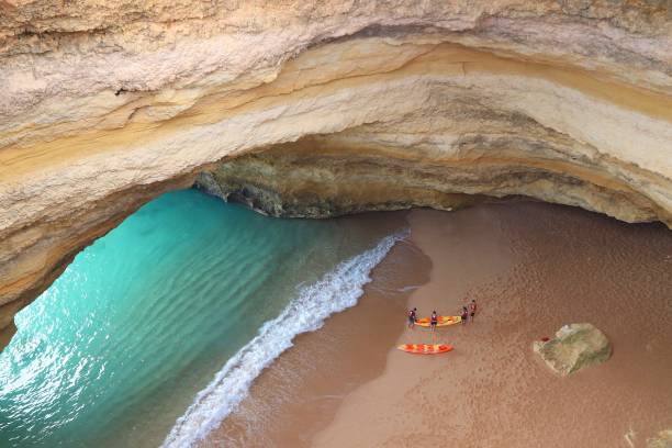 Portugal tourism attractions Sea kayaking at Benagil Beach in Algarve region, Portugal. Coastal region of Algarve attracts more than 17 million tourists annually. benagil photos stock pictures, royalty-free photos & images