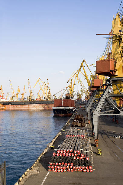 Loading cargo of metal from a port mooring stock photo