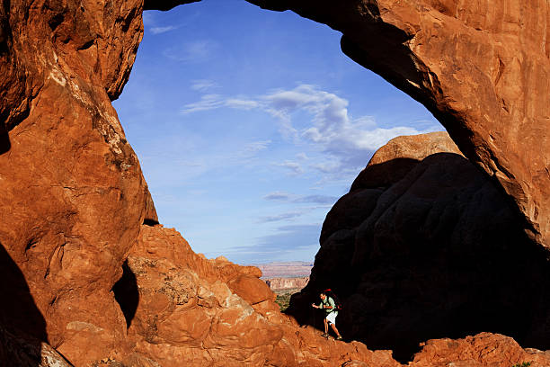 istock Backpacker Making Climb Underneath Arch In Arches National Park 118264843