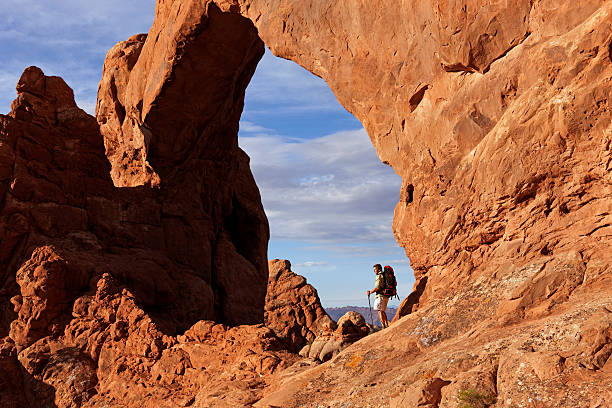 istock Backpacker Standing Under Historic Arch In Arches National Park 118264948