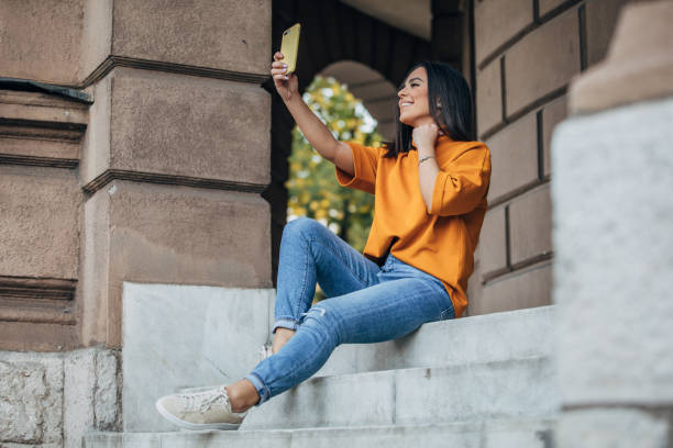 istock Beautiful woman taking a selfie on steps 1182649620