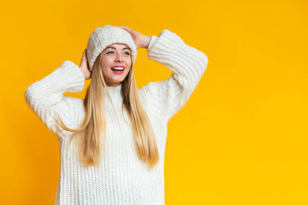 istock Delighted young woman in knitted hat looking at empty space 1182649621