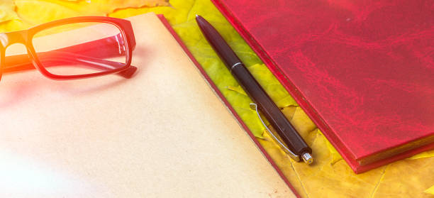 Red book with a writing pen.Open book Open book.Red book with a writing pen weltall stock pictures, royalty-free photos & images
