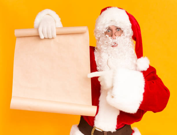 istock Santa Claus showing on wish list with copy space for text 1182650491