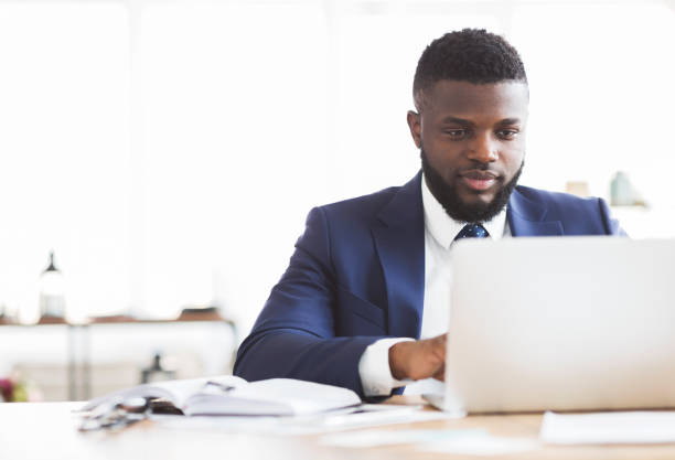 istock Concentrated businessman working with laptop in office 1182650610