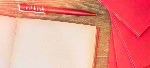 Red book with a writing pen.Open book Open book.Red book with a writing pen weltall stock pictures, royalty-free photos & images