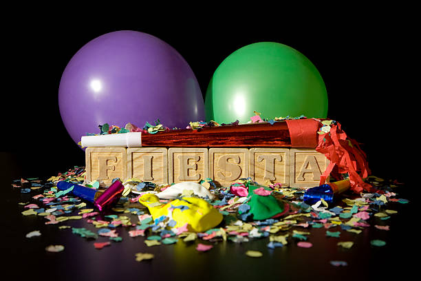 Wooden blocks spell the word FIESTA surrounded by party supplies.