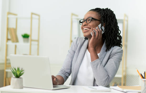 istock Black Entrepreneur Lady Talking On Cellphone Sitting In Modern Office 1182651063